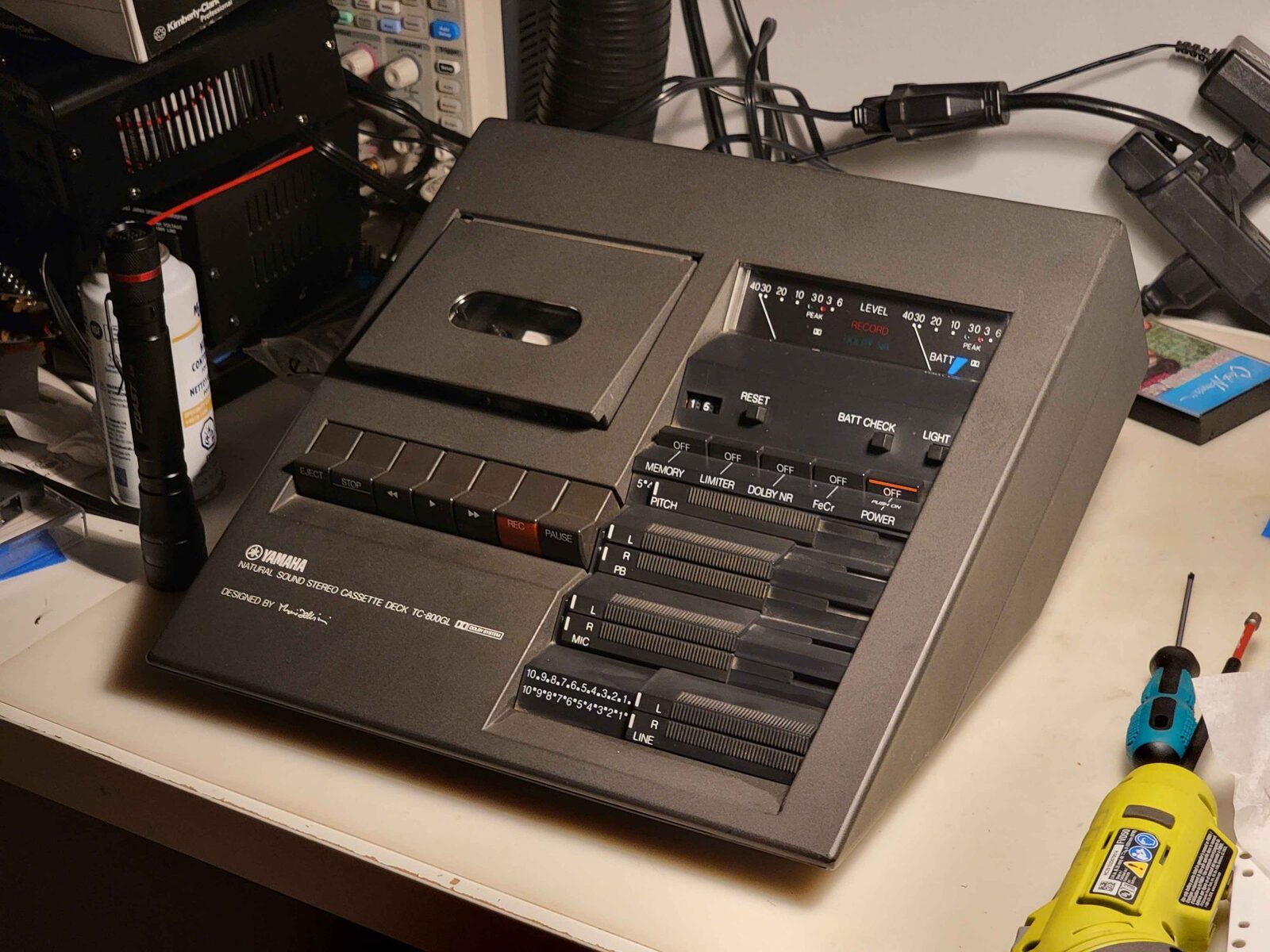 A Yamaha TC-800GL cassette deck on the workbench with an oscilloscope and tools