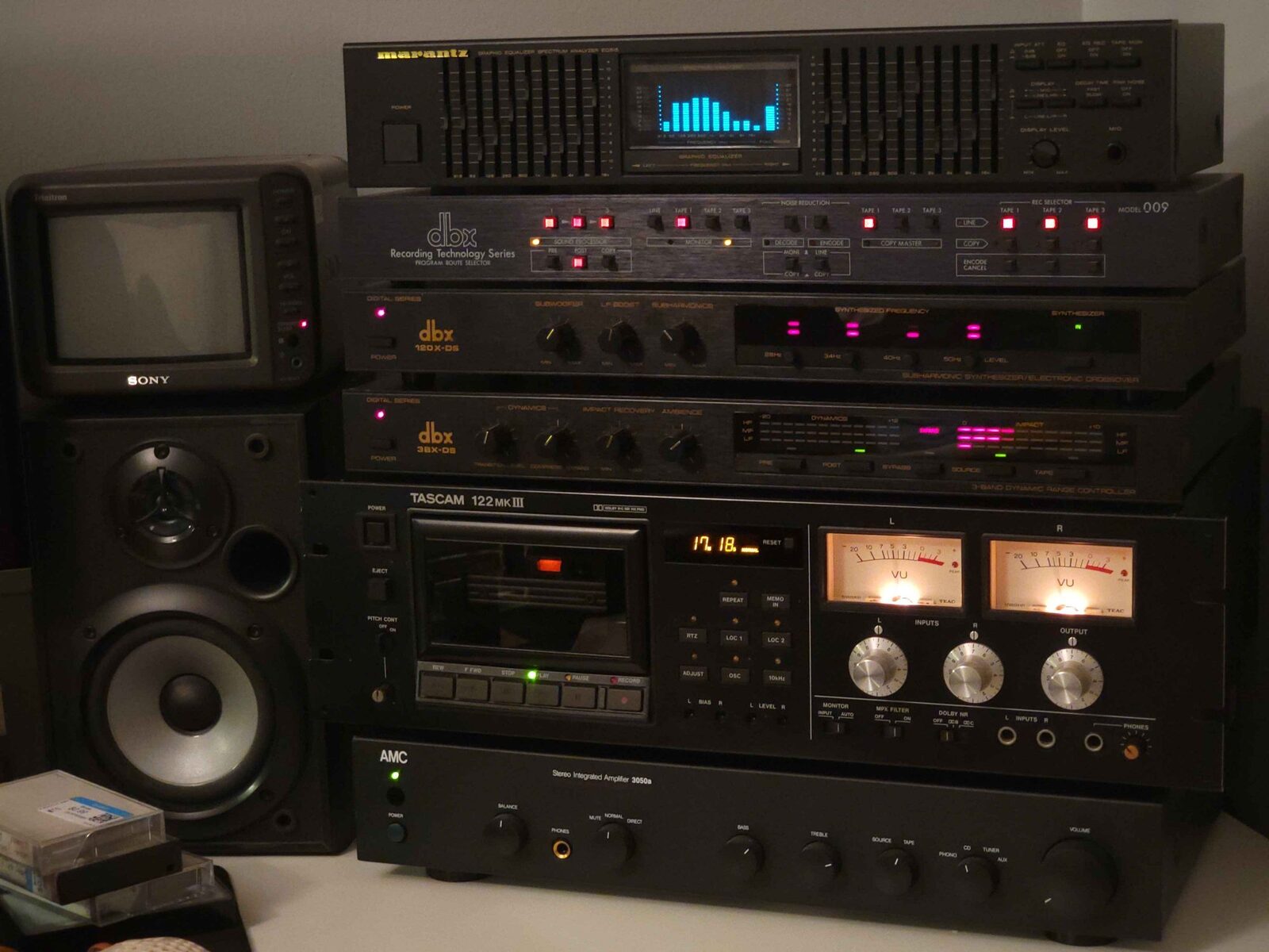 A vintage hi-fi stack with a TASCAM cassette deck, graphic equalizer and dbx processors